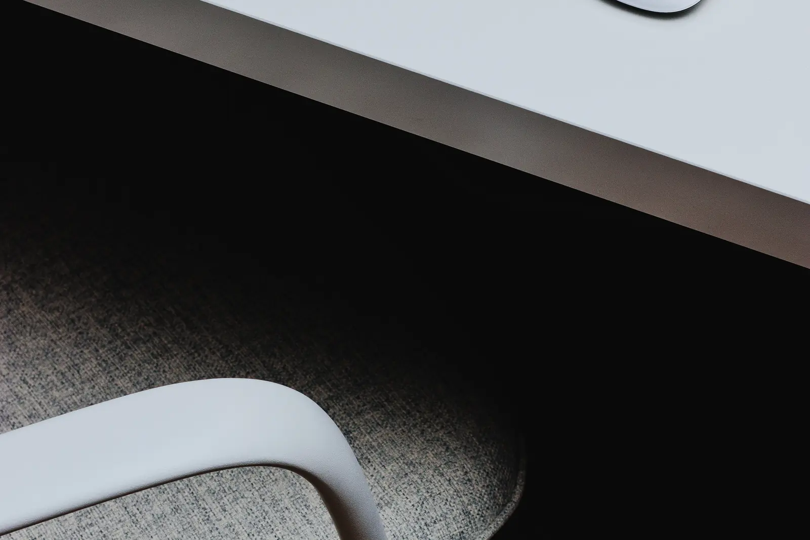 A minimal desk and chair in a home office.