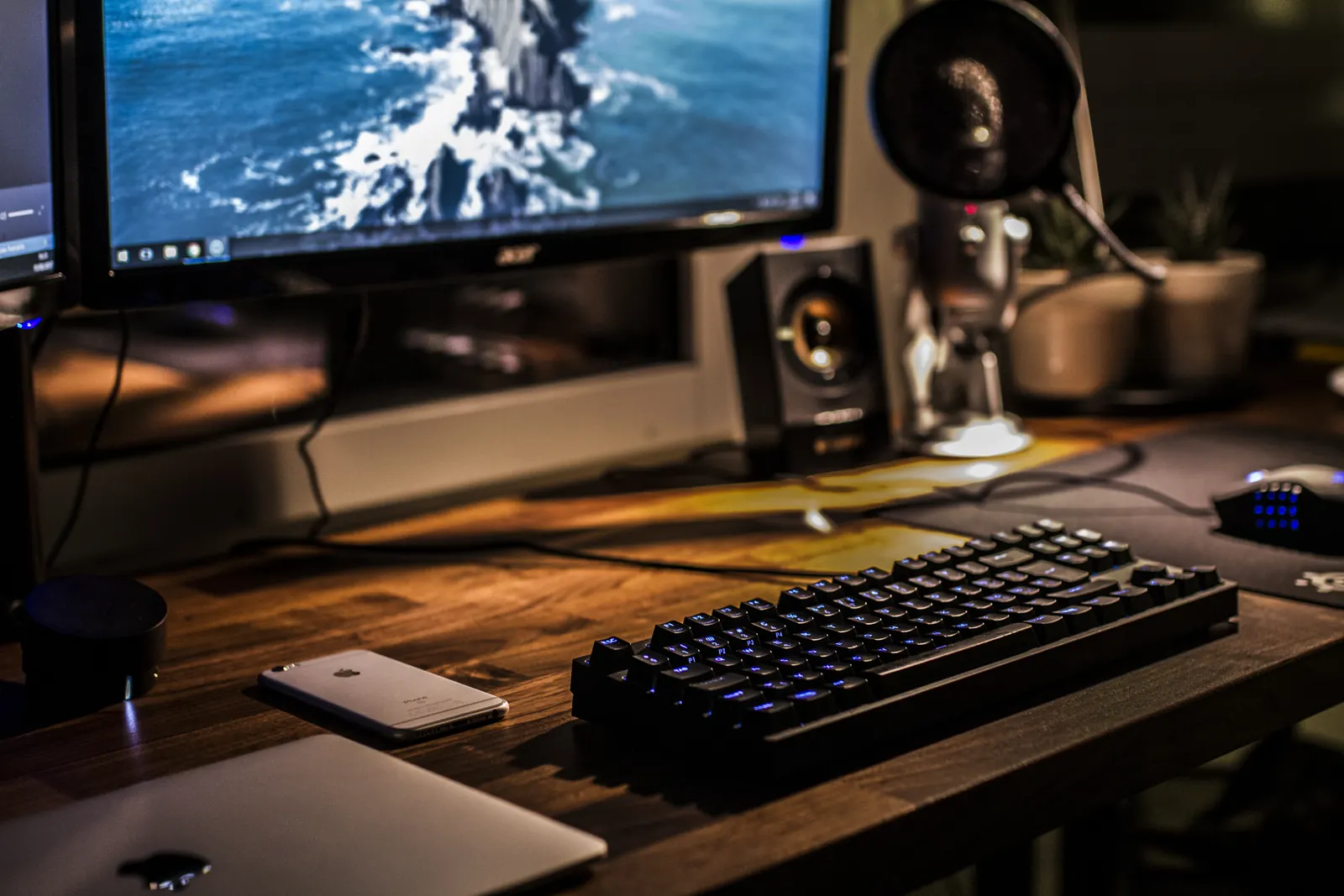 A desktop computer and mechanical keyboard at a developer workstation.