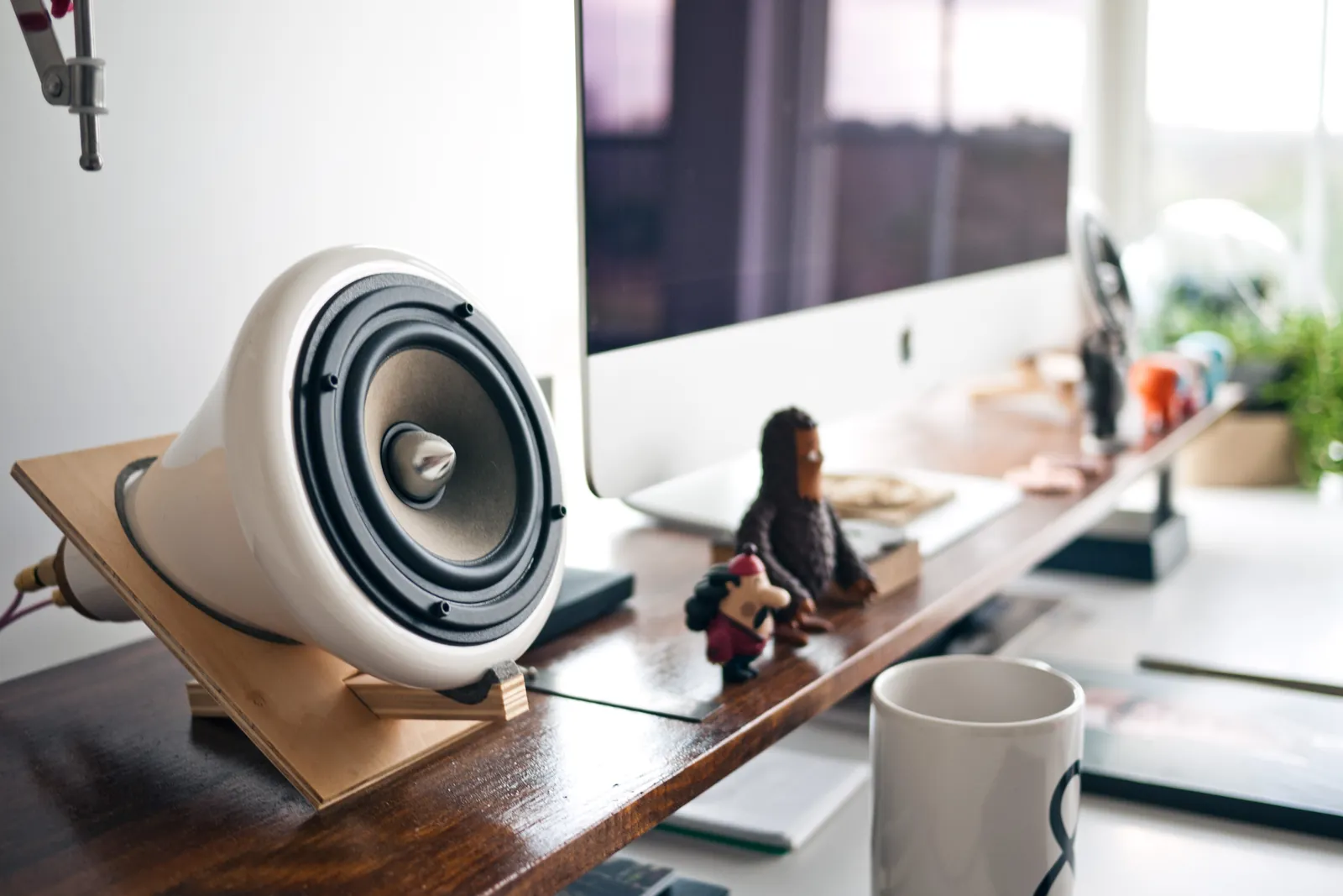 An office desk with a computer and music player.
