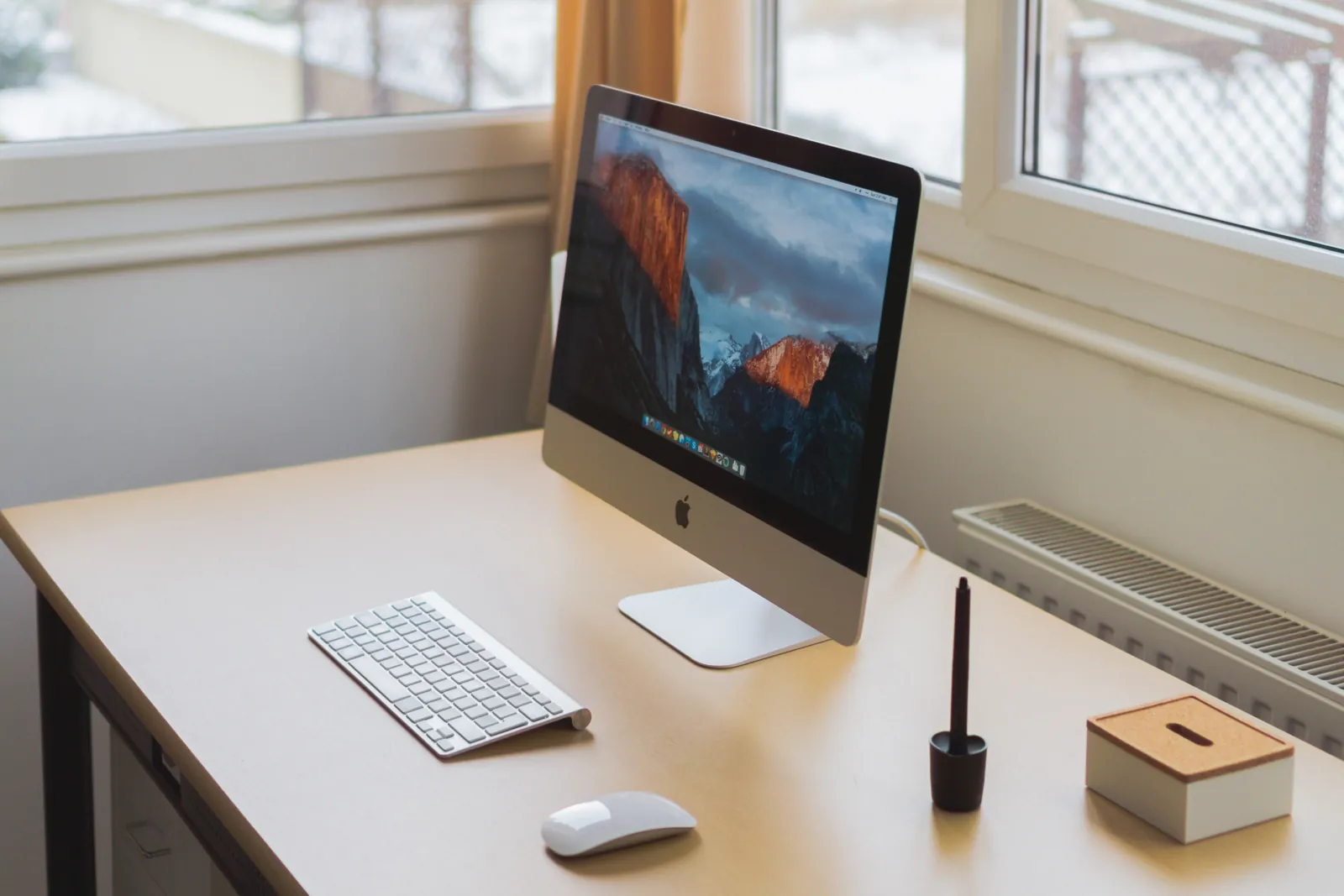 A winter workspace with a laptop and desk lamp.